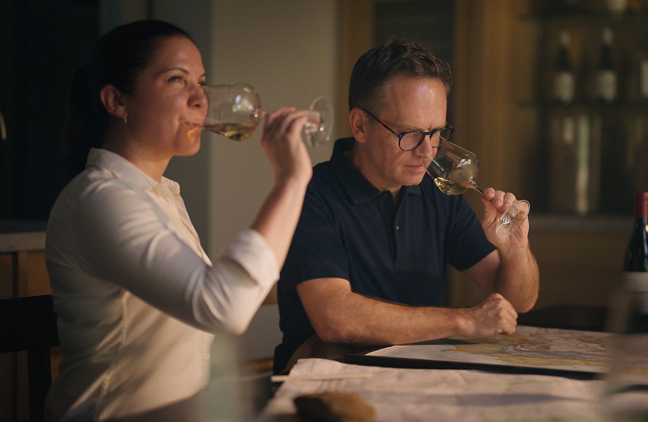 Guests tasting wine together at a counter
